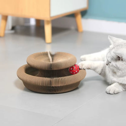 White cat playing with the Pawsome-Flex™ Magic Accordion Scratcher & Toy, featuring a flexible corrugated design and a bell ball for interactive tracking and scratching.